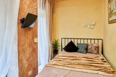 a bedroom with a bed with pillows on it at Old Town Apart FREE Parking in Vilnius