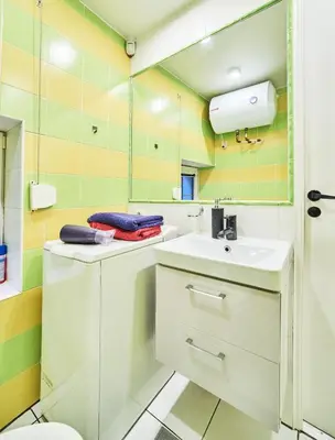 a bathroom with a sink and a mirror at Old Town Apart FREE Parking in Vilnius