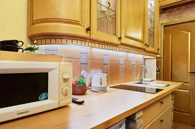 a kitchen with a microwave and a sink at Old Town Apart FREE Parking in Vilnius