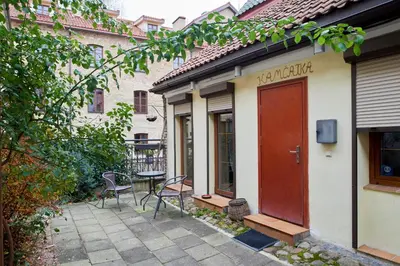 a patio with a table and chairs next to a building at Old Town Apart FREE Parking in Vilnius