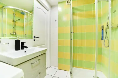 a bathroom with a sink and a shower at Old Town Apart FREE Parking in Vilnius