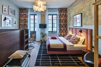 a bedroom with a bed and a tv in a room at ROOMA Apartments Boutique Old Town Self Check-in in Vilnius
