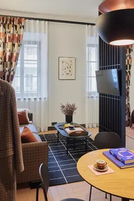 a living room with a couch and a table at ROOMA Apartments Boutique Old Town Self Check-in in Vilnius