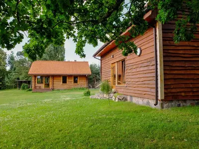 a house and a building in a yard at Bilso Sodyba in Vilkanastrai