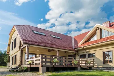 a house with a red roof at Bilso Sodyba in Vilkanastrai