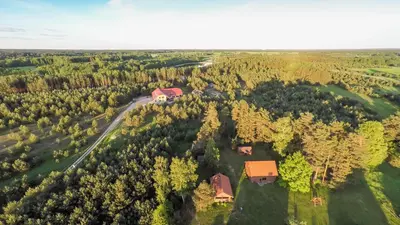 an aerial view of a house in the middle of a forest at Bilso Sodyba in Vilkanastrai