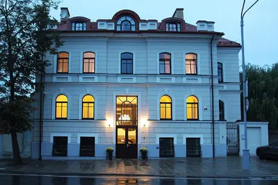 a large white building with its lights on at Moon Garden Old Town Hotel in Vilnius