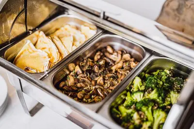 a buffet of food with broccoli and other foods at Moon Garden Old Town Hotel in Vilnius