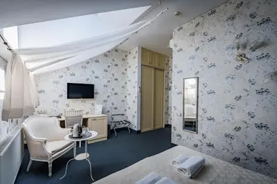 a bedroom with blue and white floral wallpaper at Moon Garden Old Town Hotel in Vilnius