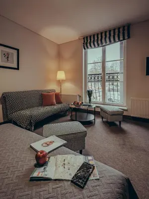 a living room with a couch and a table at Moon Garden Old Town Hotel in Vilnius