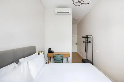 a bedroom with a bed and a table at St Casimir Apartments in Vilnius