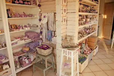 a room filled with shelves filled with lots of dolls at Lavender Village in Kiemeliai