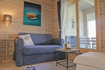 a living room with a couch and a table at Lavender Village in Kiemeliai