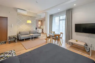 a living room with a couch and a table at Eva R Apartments in Druskininkai