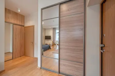a sliding glass door in a room with a bedroom at Eva R Apartments in Druskininkai