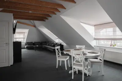 a living room with a white table and chairs at Laurentroom Oldtown in Ukmergė
