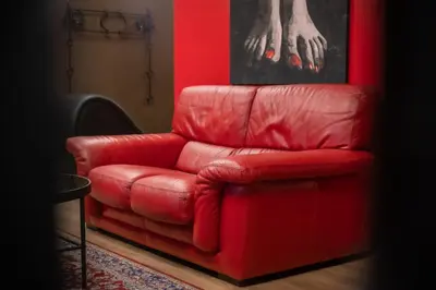 a red leather reclining chair in a red room at BDSM Red Apartments in Vilnius