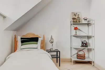 a bedroom with a bed and white shelves at Spacious - 140 square meters Apartment, Vilnius City Centre in Vilnius