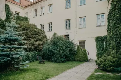 a garden with a christmas tree in front of a building at Spacious - 140 square meters Apartment, Vilnius City Centre in Vilnius