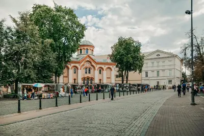 a building on a street with people walking in front of it at Spacious - 140 square meters Apartment, Vilnius City Centre in Vilnius