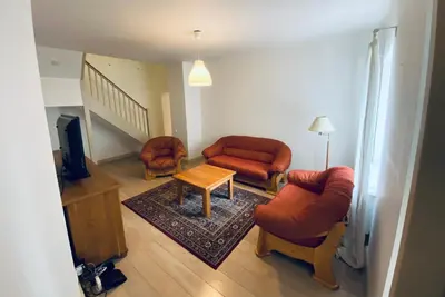 a living room with two chairs and a table at Spacious - 140 square meters Apartment, Vilnius City Centre in Vilnius