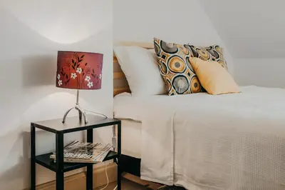 a bedroom with a bed with a lamp on a night stand at Spacious - 140 square meters Apartment, Vilnius City Centre in Vilnius