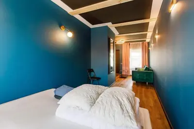 a bedroom with blue walls and a white bed at Apartments in Kaunas in Kaunas