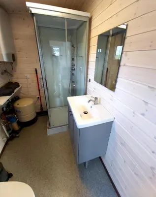 a bathroom with a sink and a shower at Siesarties Namukas in Mindūnai