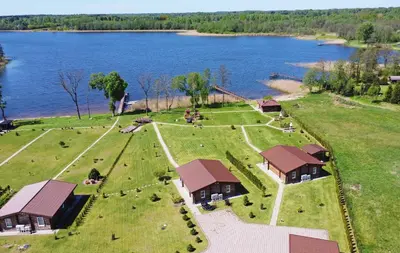 an aerial view of a farm with a lake at Vastapo Vilos in Kaniūkai