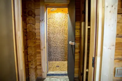 a bathroom with a shower with a glass door at Vastapo Vilos in Kaniūkai