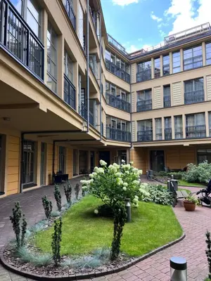 an apartment building with a garden in the courtyard at Vilnius Apartments & Suites – Old Town in Vilnius