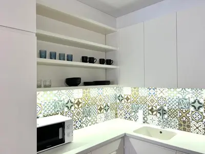 a kitchen with a sink and a microwave at Vilnius Apartments & Suites – Old Town in Vilnius