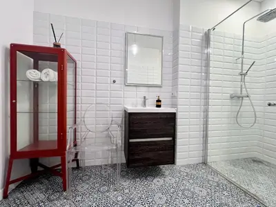 a bathroom with a sink and a mirror and a shower at Vilnius Apartments & Suites – Old Town in Vilnius