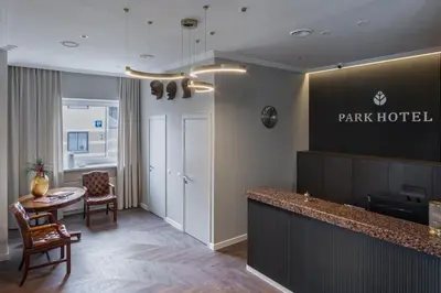 a hotel lobby with a park hotel sign on the wall at Park Hotel Šiauliai SPA & Conference in Šiauliai