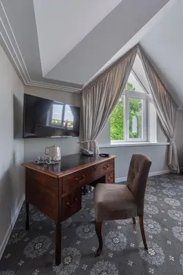 an office with a desk and a chair and a window at Park Hotel Šiauliai SPA & Conference in Šiauliai