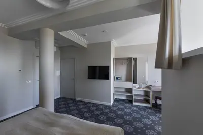 a hotel room with a bed and a flat screen tv at Park Hotel Šiauliai SPA & Conference in Šiauliai
