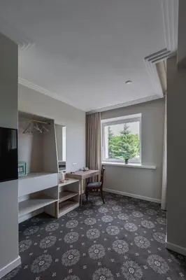 a hotel room with a desk and a window at Park Hotel Šiauliai SPA & Conference in Šiauliai