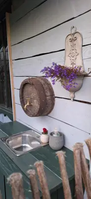 a kitchen counter with a sink and a wooden barrel at PO NENDRIŲ STOGU in Šiauliai