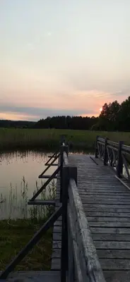 a wooden bridge over a body of water at PO NENDRIŲ STOGU in Šiauliai