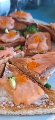 a plate of food with bread with salmon and broccoli at PO NENDRIŲ STOGU in Šiauliai