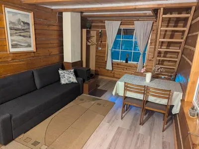 a living room with a couch and a table at Namelis prie ežero in Miežoniai