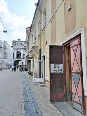 an empty street in a city with a building at 25 Hours Hostel in Vilnius