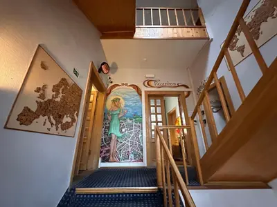 a hallway with a mural of a woman on the wall at 25 Hours Hostel in Vilnius