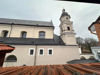 a large white building with a clock tower at 25 Hours Hostel in Vilnius