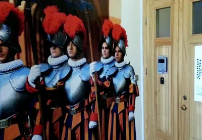 a group of men in uniform standing in front of a mirror at 25 Hours Hostel in Vilnius
