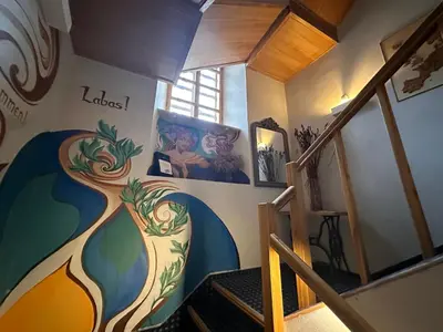 a staircase with a mural on the wall at 25 Hours Hostel in Vilnius