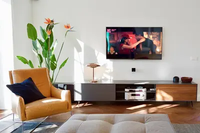 a living room with a couch and a tv on a wall at Vilnius Apartments & Suites - Town Hall in Vilnius