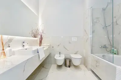 a bathroom with a sink and a toilet and a shower at Vilnius Apartments & Suites - Town Hall in Vilnius