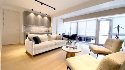 a living room with a white couch and a table at Vilnius Apartments & Suites - Town Hall in Vilnius