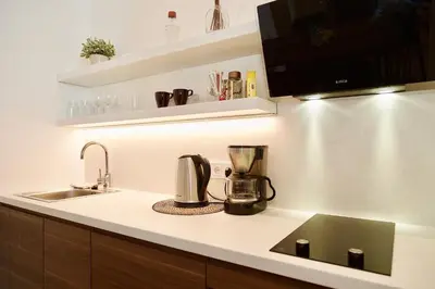 a kitchen with a coffee maker on a counter at Vilnius Apartments & Suites - Town Hall in Vilnius